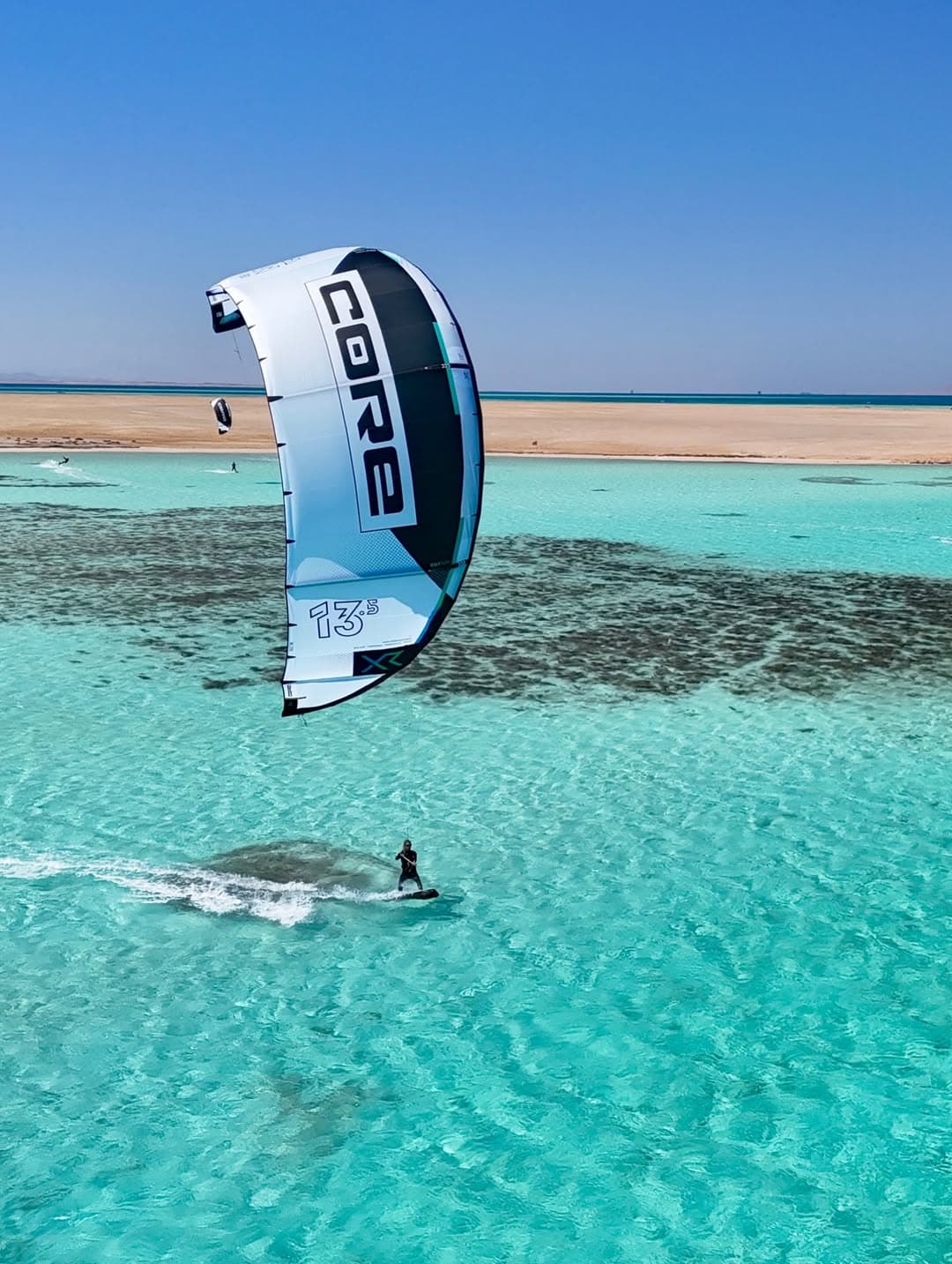 Rider carving across flat water during a private lesson